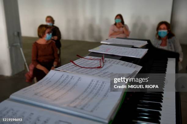 Singers of the Apostol Santiago choir keep their social distance as they attend their first rehearsal after the loosening of a national lockdown to...