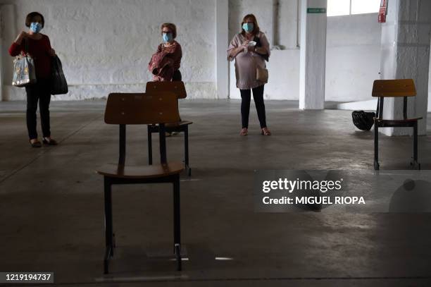 Singers of the Apostol Santiago choir, wearing face masks, arrive to attend the first rehearsal after the loosening of a national lockdown to stop...