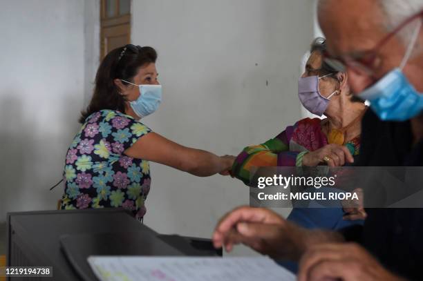 Singers of the Apostol Santiago choir elbow bump in Vigo, on June 10, 2020 before their first rehearsal after the loosening of a national lockdown to...