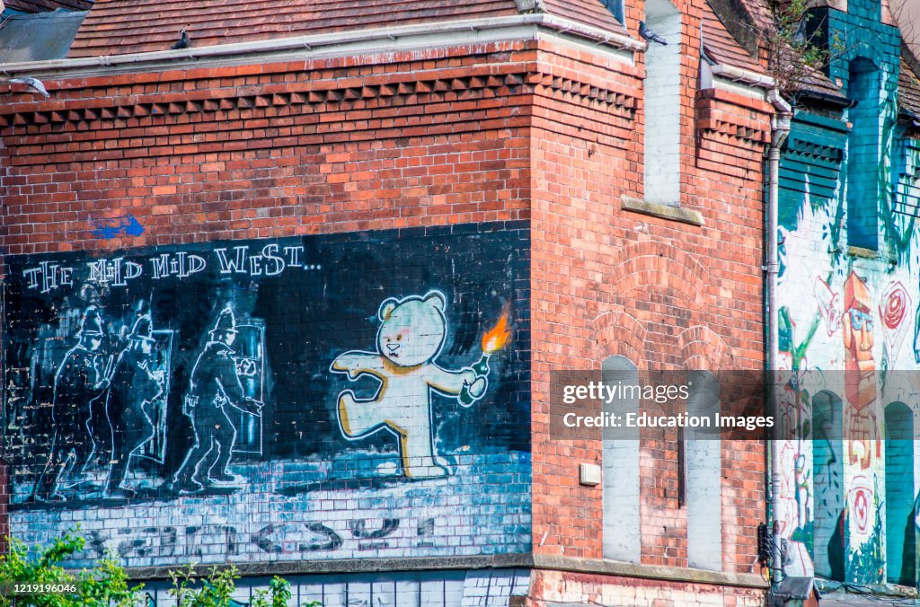 The famous Banksy art work 'The Mild Mild West' at Stokes Croft a colorful district of Bristol full of street art. Avon. England. UK.
