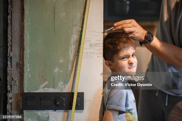 a father with a little son having fun together - height chart stock pictures, royalty-free photos & images