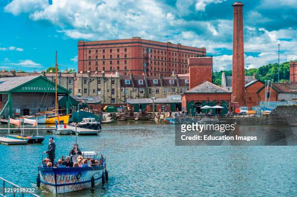 Floating Harbor at Underfall Yard with Victorian pump room & an old tobacco warehouse to the rear, Bristol, Avon, England, UK.
