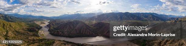 cauca, one of colombia biggest river stream surrounded by magnificient mountains and hills - antioquia stock pictures, royalty-free photos & images