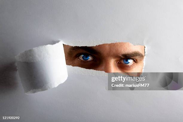 i see you! - man looking through keyhole - vouyer stock pictures, royalty-free photos & images