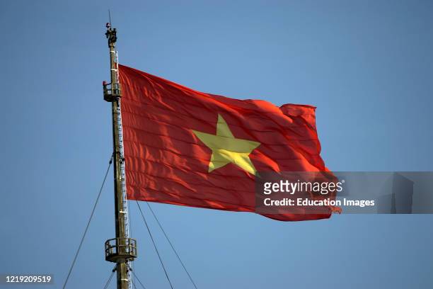 Red and yellow five point star national flag flying on the Flag Tower in The Citadel Hue Vietnam.