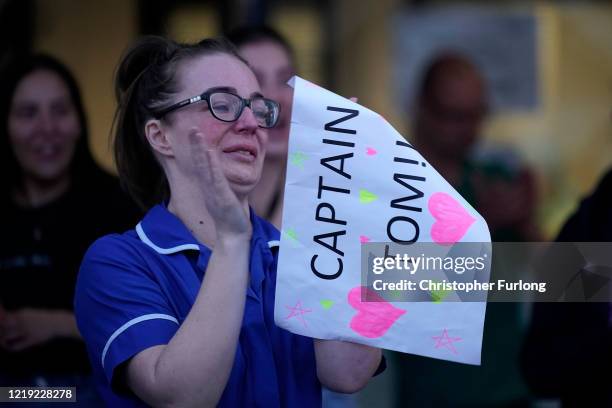 Nurse at Aintree University Hospital sheds a tear and as she pays tribute to super fundraiser Captain Tom Moore during the "Clap for Our Carers" and...