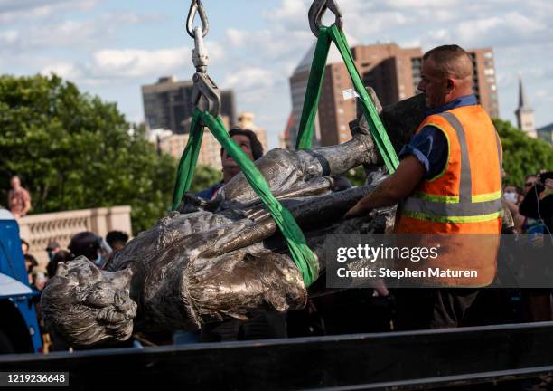 Statue of Christopher Columbus, which was toppled by protesters, is loaded onto a truck on the grounds of the State Capitol on June 10, 2020 in St...