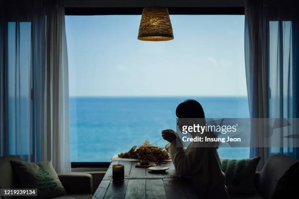young woman drinking coffee - coffee window stock pictures, royalty-free photos & images