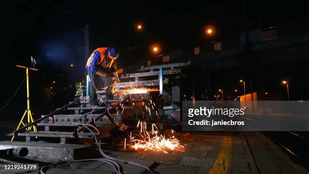 industrial welding. sparks splashing all over metal construction - sucata imagens e fotografias de stock
