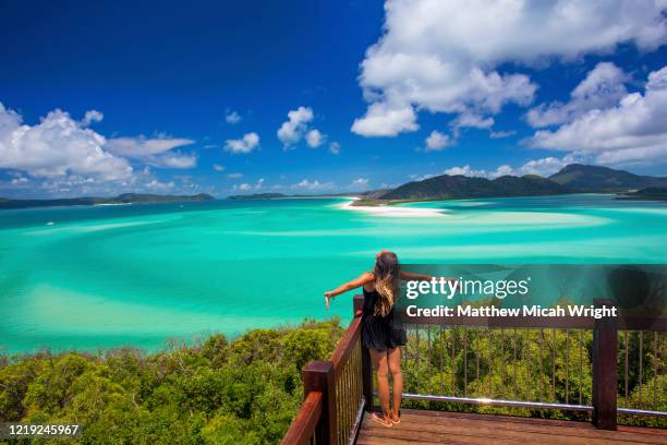 a woman takes in the beautiful view of the whitsundays. - whitehaven beach stockfoto's en -beelden