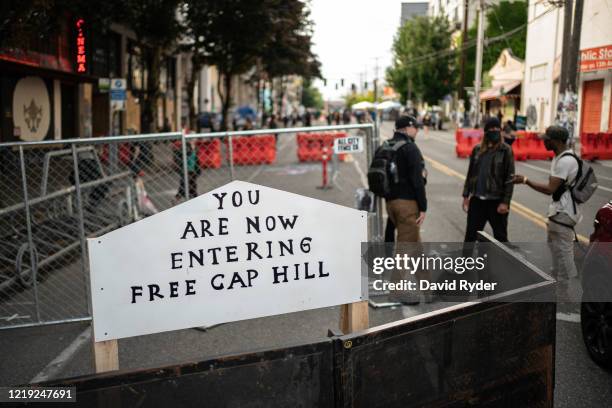 Sign is seen on a barrier at an entrance to the so-called "Capitol Hill Autonomous Zone" on June 10, 2020 in Seattle, Washington. The zone includes...