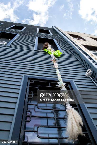 Drag queen Suburbia poses for photos out her window before hosting Susanne Bartsch's 'ONTOP' ONLINE via ZOOM on April 16, 2020 in New York City.
