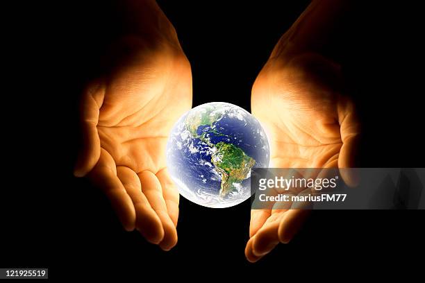 hands with glowing earth - glowing orb stock pictures, royalty-free photos & images