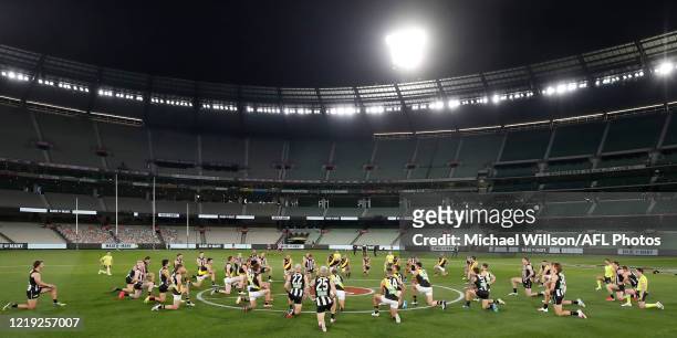Players take a knee to support the Black Lives Matter movement before the 2020 AFL Round 02 match between the Collingwood Magpies and the Richmond...