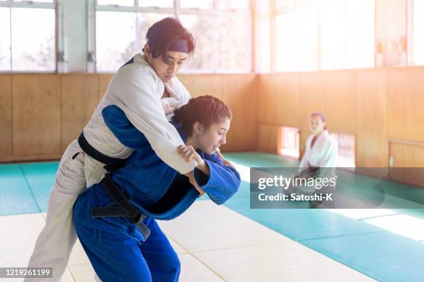 young judo athletes practicing in dojo - judo stock pictures, royalty-free photos & images