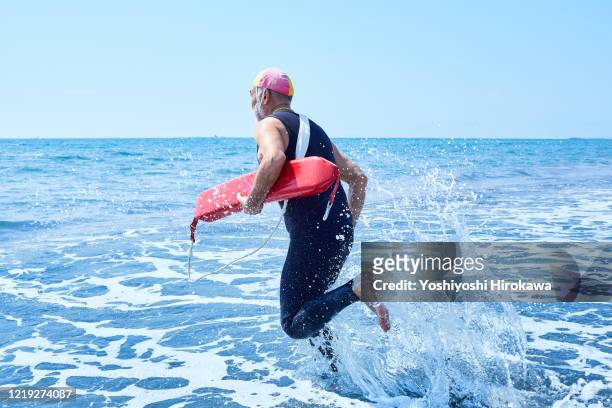 senior men in lifesaving training - surf life saving stockfoto's en -beelden
