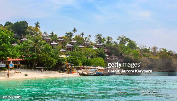 longtail boat in front of phi phi hotel on koh phi phi, thailand - thailand hotel stock pictures, royalty-free photos & images