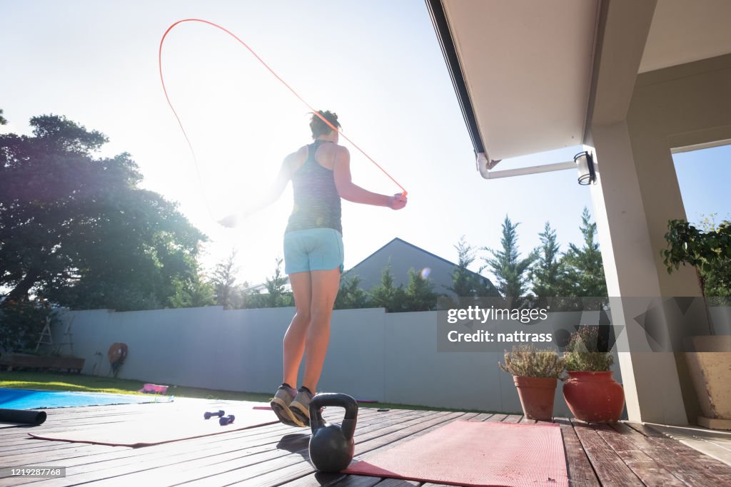 Woman keeping fit by doing some jump rope