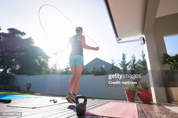 woman keeping fit by doing some jump rope - skipping rope stock pictures, royalty-free photos & images