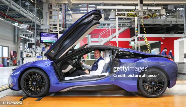 June 2020, Saxony, Leipzig: Plant manager Hans-Peter Kemser sits in the last BMW i8 at the end of the production line at the BMW plant in Leipzig....