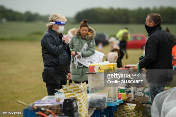 Shoppers peruse items for sale at the Strawberry Fields car boot sale in Bridlington, north-east England on June 11, 2020. - The car boot sale, has...
