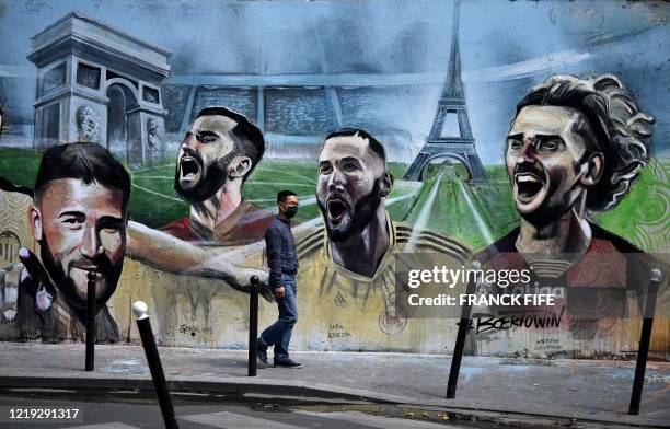 Picture taken on June 10 shows a detail of a mural signed Ernesto Novo in a street in Paris depicting French football players playing in Spain's La...