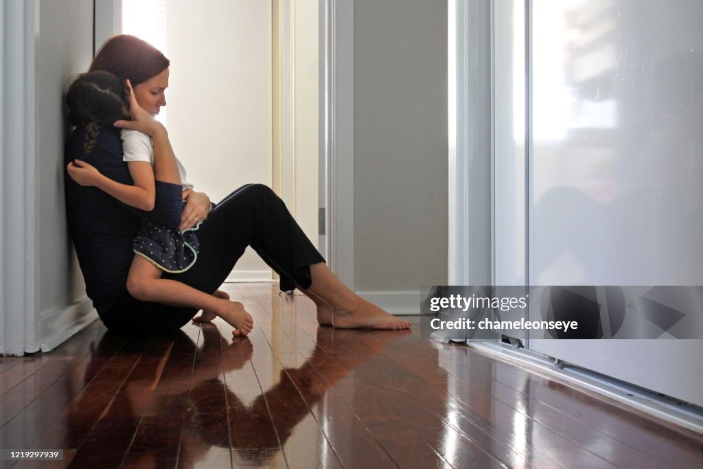 Sad mother hugging her young daughter