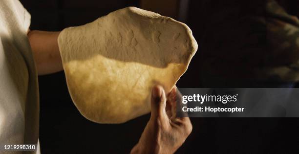 a native american (navajo) woman's hands form a raw tortilla (fry bread) - tortilla stock pictures, royalty-free photos & images