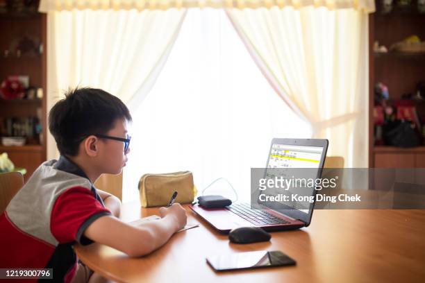 a student learning by doing schoolwork at home using a computer e-classes during covid-19 pandemic. distance learning online education or stay at home. - tuition assistance stock pictures, royalty-free photos & images