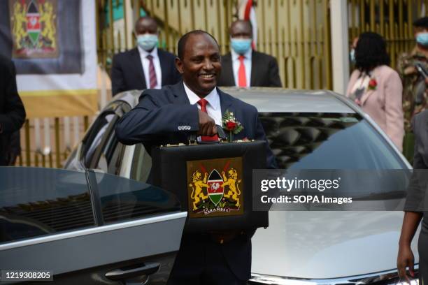 Cabinet Secretary for National Treasury in Kenya Ukur Yatani poses for a photo outside the National Treasury building with the budget briefcase...