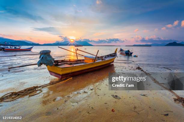 fisherman boats at black sand beach village in langkawi, malaysia. - langkawi stock-fotos und bilder