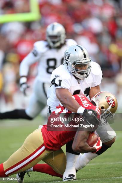 Madieu Williams of the San Francisco 49ers gets tackled after making an interception during the pre-season game against the Oakland Raiders at...
