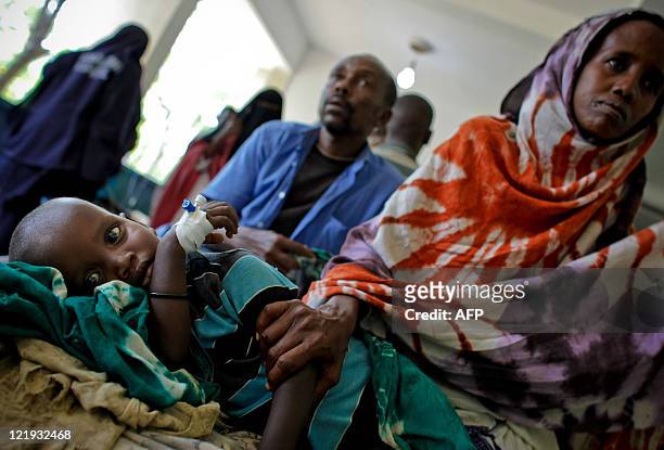 In a photograph released by the African Union-United Nations Information Support Team on August 10, 2011 a mother comforts her malnourished and...