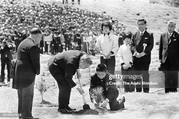Emperor Hirohito plants a young tree during the 22nd National Tree Planting Festival at Mt. Sanbe on April 18, 1971 in Oda, Shimane, Japan.