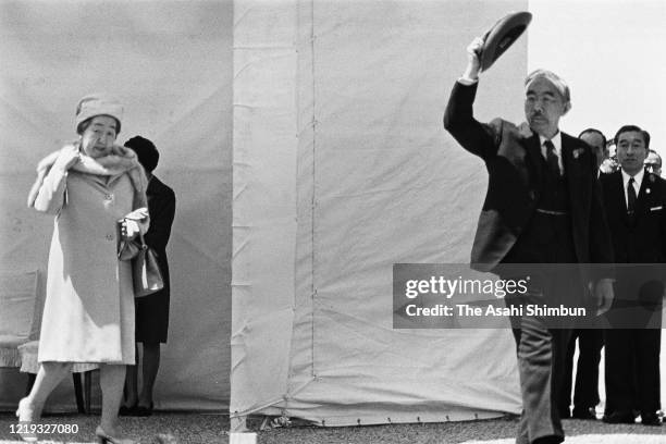 Emperor Hirohito and Empress Nagako wave to attendees on arrival at the 22nd National Tree Planting Festival at Mt. Sanbe on April 18, 1971 in Oda,...