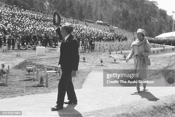 Emperor Hirohito and Empress Nagako wave to attendees on arrival at the 22nd National Tree Planting Festival at Mt. Sanbe on April 18, 1971 in Oda,...