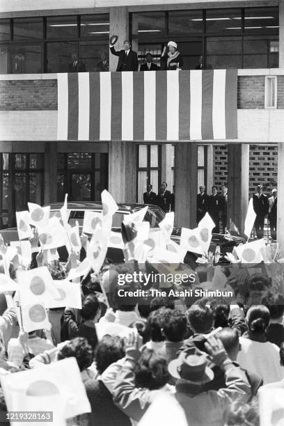 Emperor Hirohito and Empress Nagako wave to well-wishers from a balcony of the Oda Civic Hall on April 19, 1971 in Oda, Shimane, Japan.