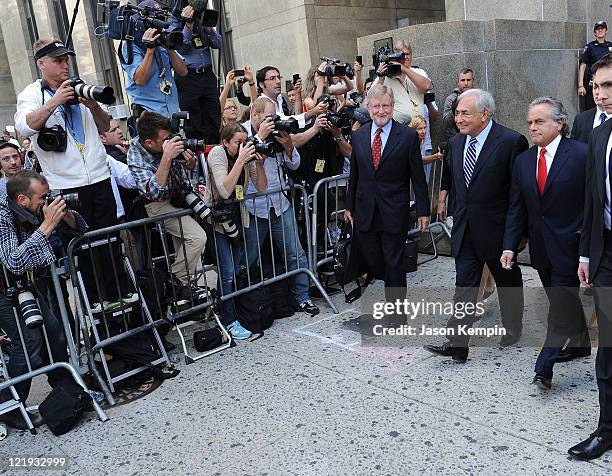 Lawyer William Taylor, Dominique Strauss-Kahn and lawyer Benjamin Brafman leave Manhattan Criminal Court after attending a status hearing on the...