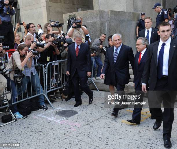 Lawyer William Taylor, Dominique Strauss-Kahn and lawyer Benjamin Brafman leave Manhattan Criminal Court after attending a status hearing on the...