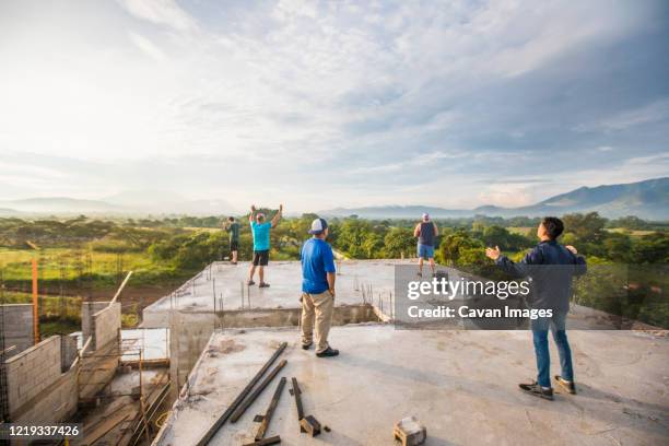 group of men praising god from rooftop in the morning. - temple of praise stock pictures, royalty-free photos & images