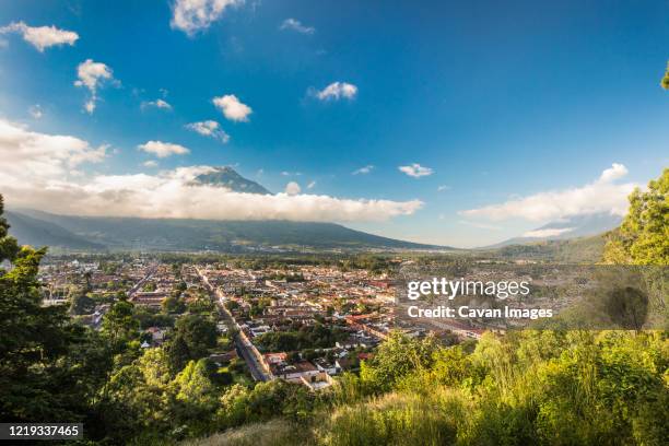 high angle view of antigua, guatemala and volcano agua. - antigua western guatemala stock pictures, royalty-free photos & images