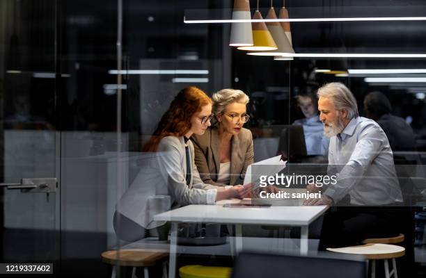 business people working late in the office - retirement decisions stock pictures, royalty-free photos & images