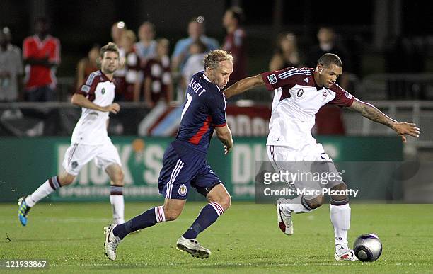 Caleb Folan of the Colorado Rapids battles Simon Elliott of Chivas USA for control of a ball during their game at Dick's Sporting Goods Park August...