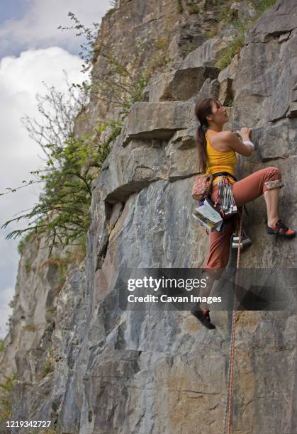 female climber on a difficult climb in the wye valley / south wales - crag stock pictures, royalty-free photos & images