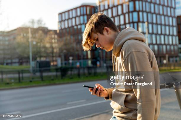 teenage boy using a smartphone - teenagers only stock pictures, royalty-free photos & images