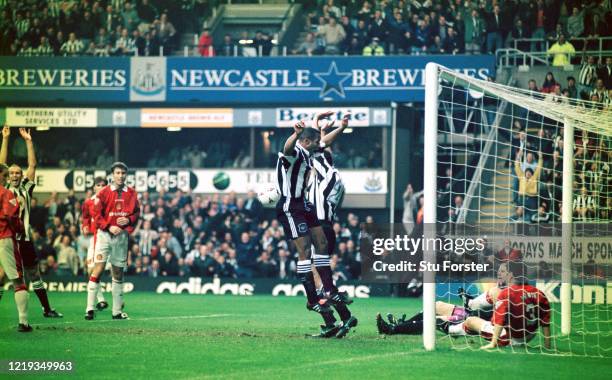 Newcastle striker Les Ferdinand celebrates after Darren Peacock scores the opening goal despite the attempts on the goal line of Denis Irwin during...