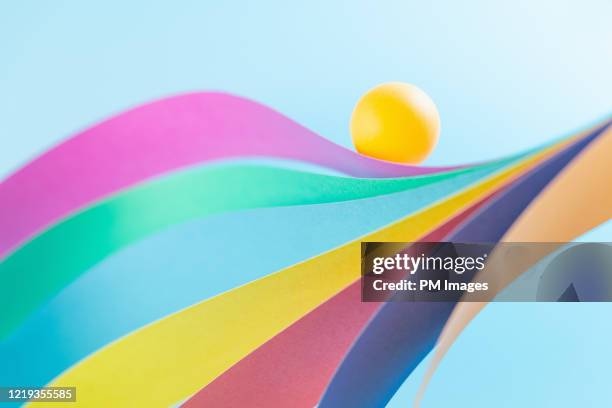 abstract, ball on multicolored wave - paper ball stock-fotos und bilder