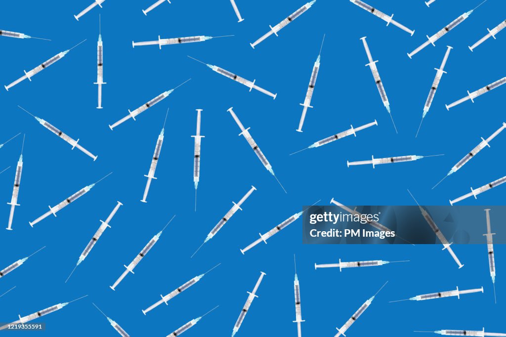 Random syringes on blue