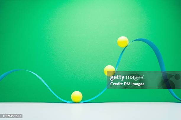 abstract, yellow balls on blue wave - paper ball stock-fotos und bilder
