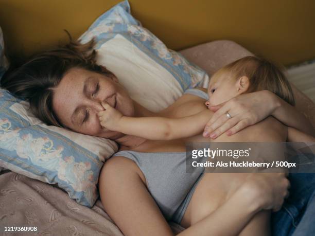 Portrait of woman breastfeeding her daughter, Russia